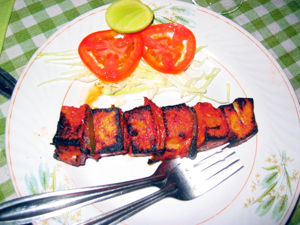 Paneer tikka skewers grilled in the tandoor