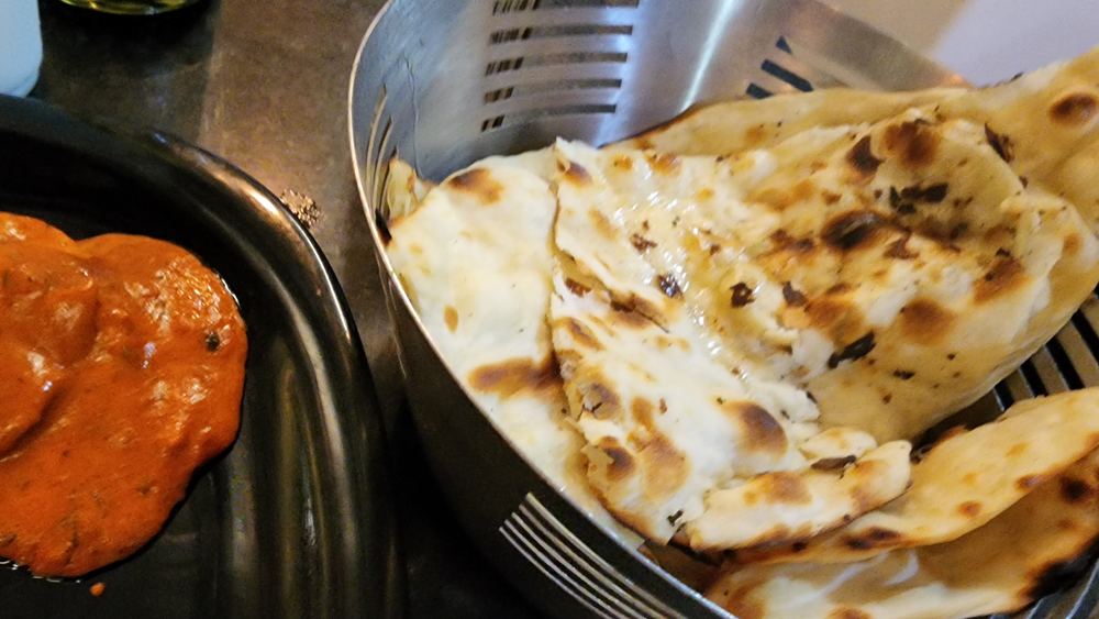 Basket of fresh tandoori breads and naan